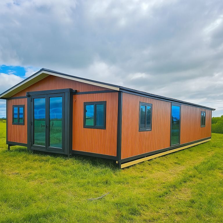 Modern 40ft expandable house with a stylish exterior, double-glazed windows, and reinforced doors set in New Zealand countryside